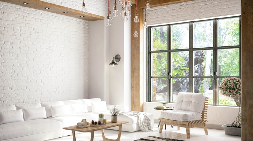 a white, modern living room with dark framed windows