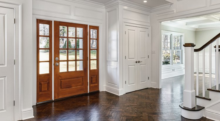 front entry way showcasing a wood door with squares of glass at the top