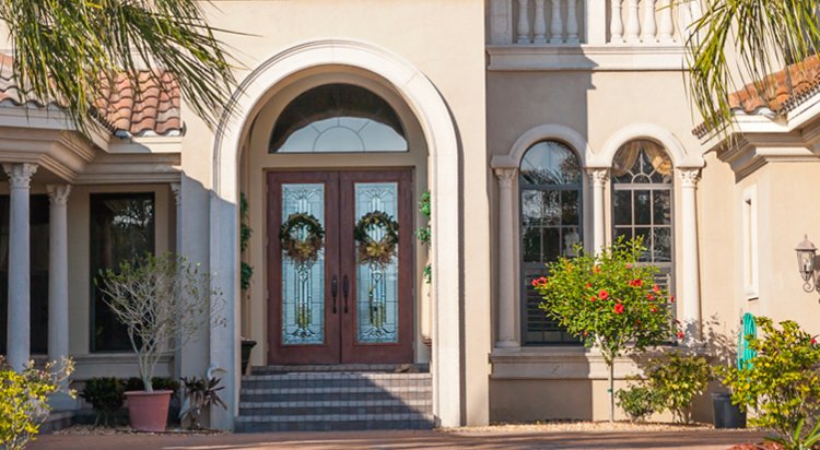 home exterior with tall window paned double front doors